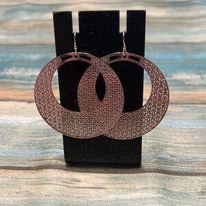 Silver hoop earrings with a wire back. Detailed pattern.